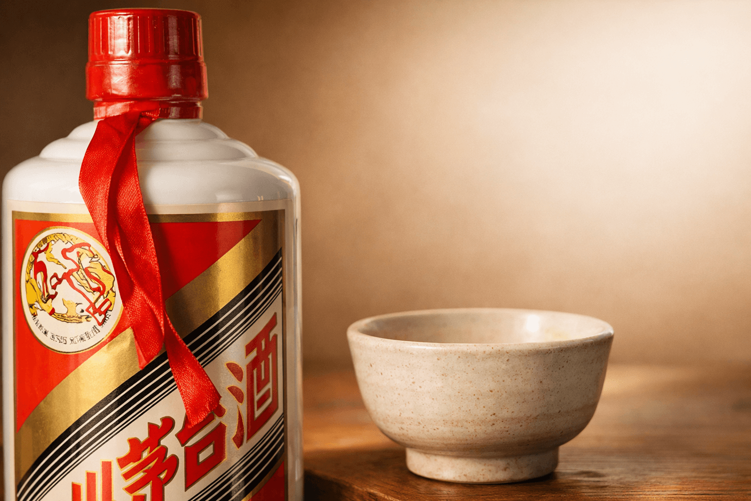 Kweichow Moutai bottle displayed beside a traditional ceramic tasting cup.