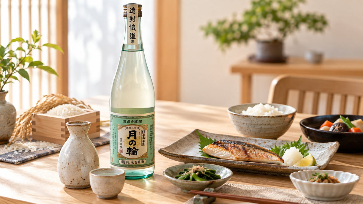 Japanese sake bottle served with grilled fish, rice, and side dishes